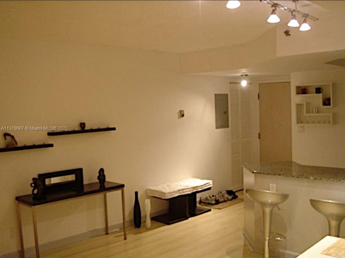 8911 Collins Avenue, Unit 1004 Surfside, FL 33154 - Photo 10 of 20 a bathroom with a sink a toilet and mirror