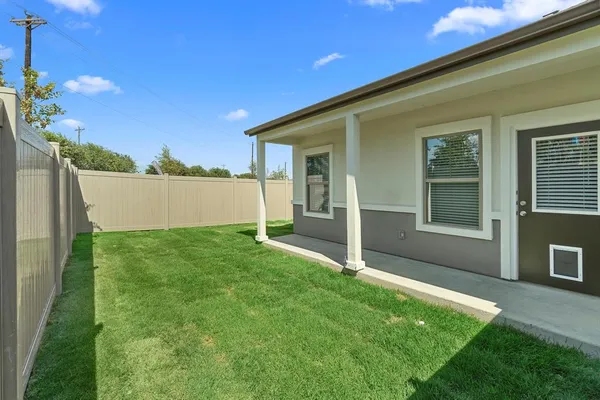a view of an house with backyard space and garden
