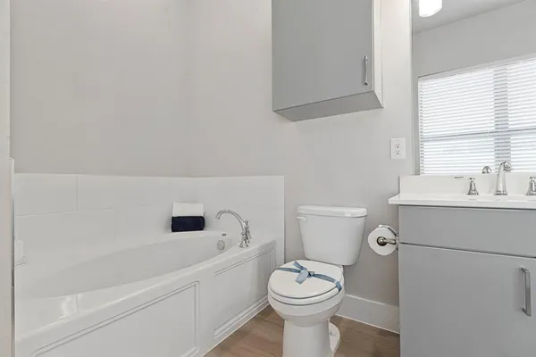 a spacious bathroom with a double vanity sink a mirror and a shower