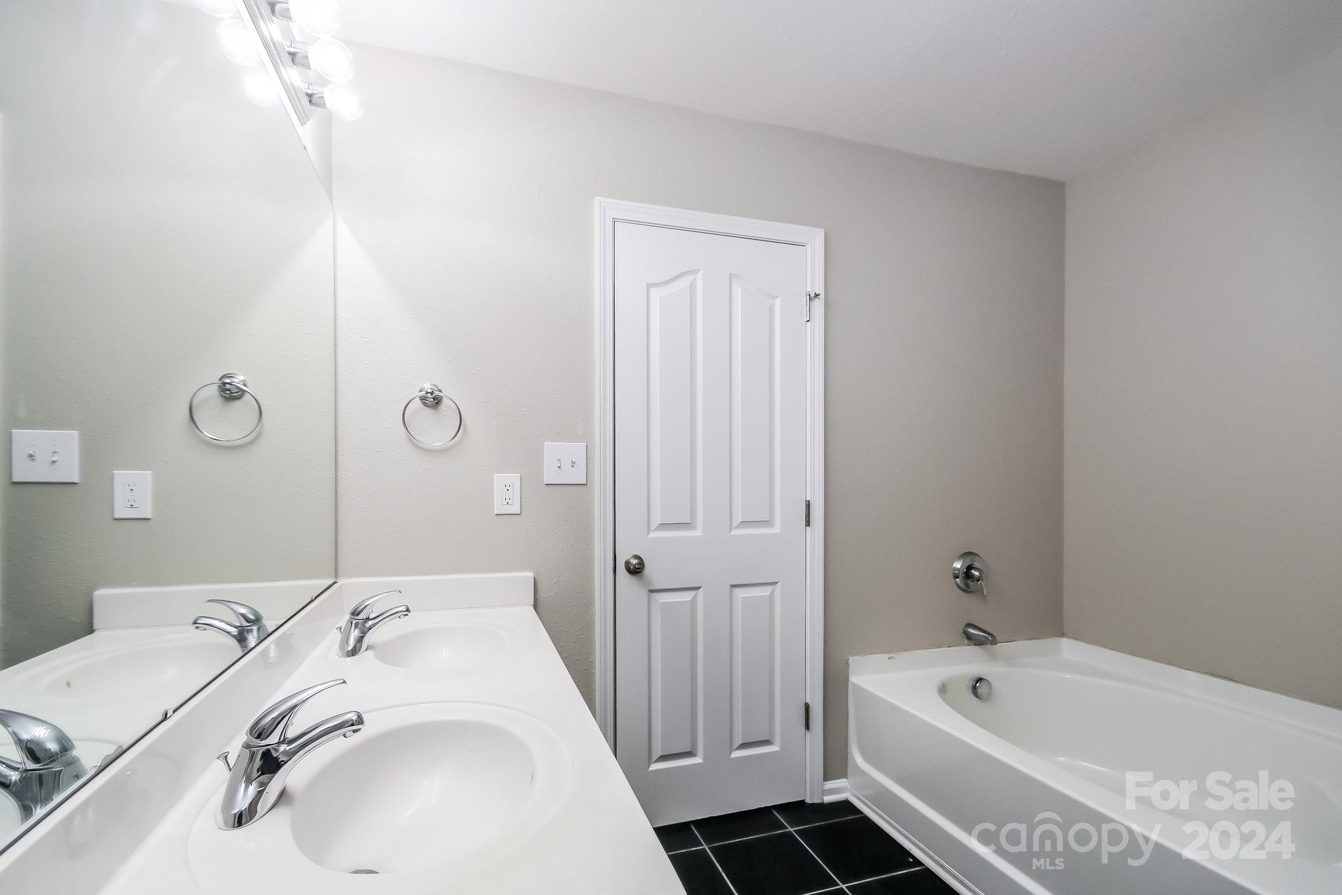 2315 Gooseberry Road Charlotte, NC 28208 - Photo 13 of 22 a bathroom with a tub sink and mirror