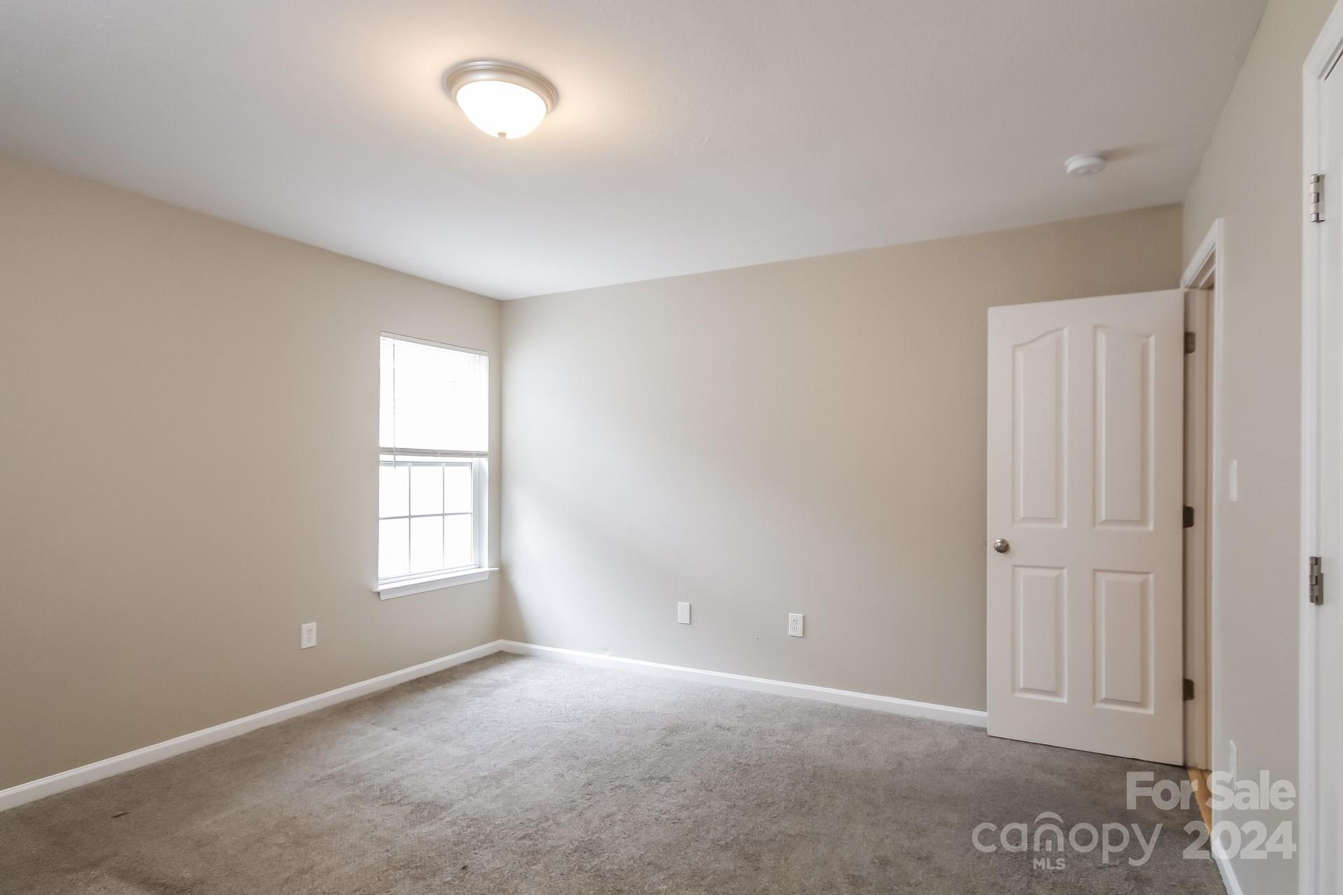 2315 Gooseberry Road Charlotte, NC 28208 - Photo 15 of 22 an empty room with windows and closet