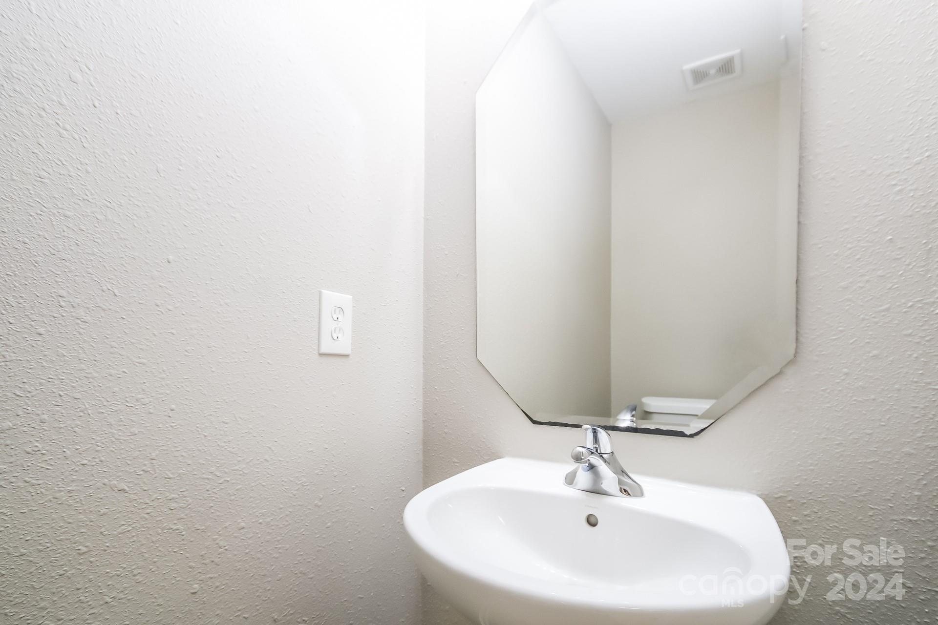 2315 Gooseberry Road Charlotte, NC 28208 - Photo 21 of 22 a bathroom with a sink and a mirror