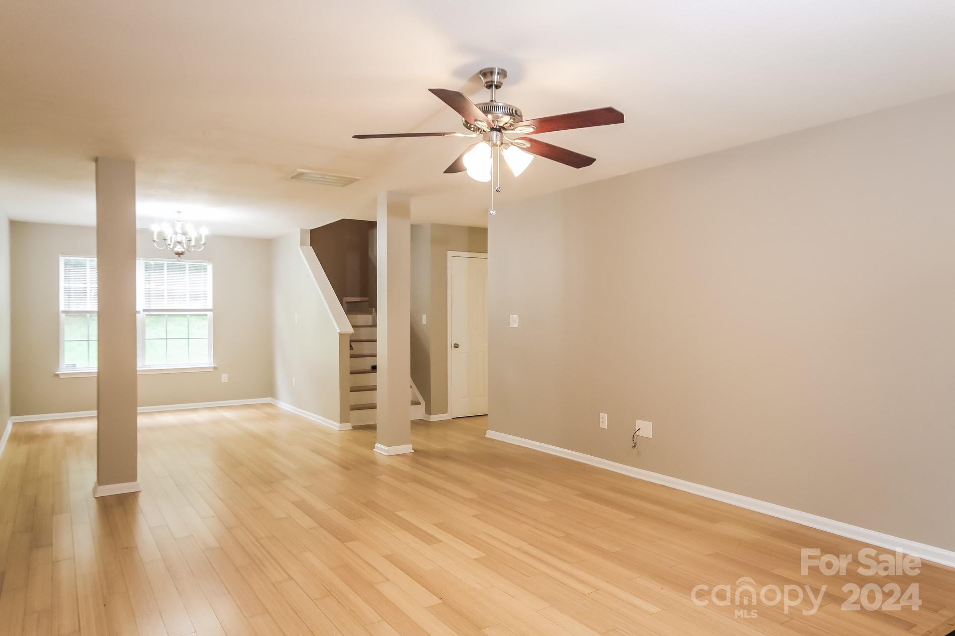 2315 Gooseberry Road Charlotte, NC 28208 - Photo 5 of 22 a view of an empty room with wooden floor and a window
