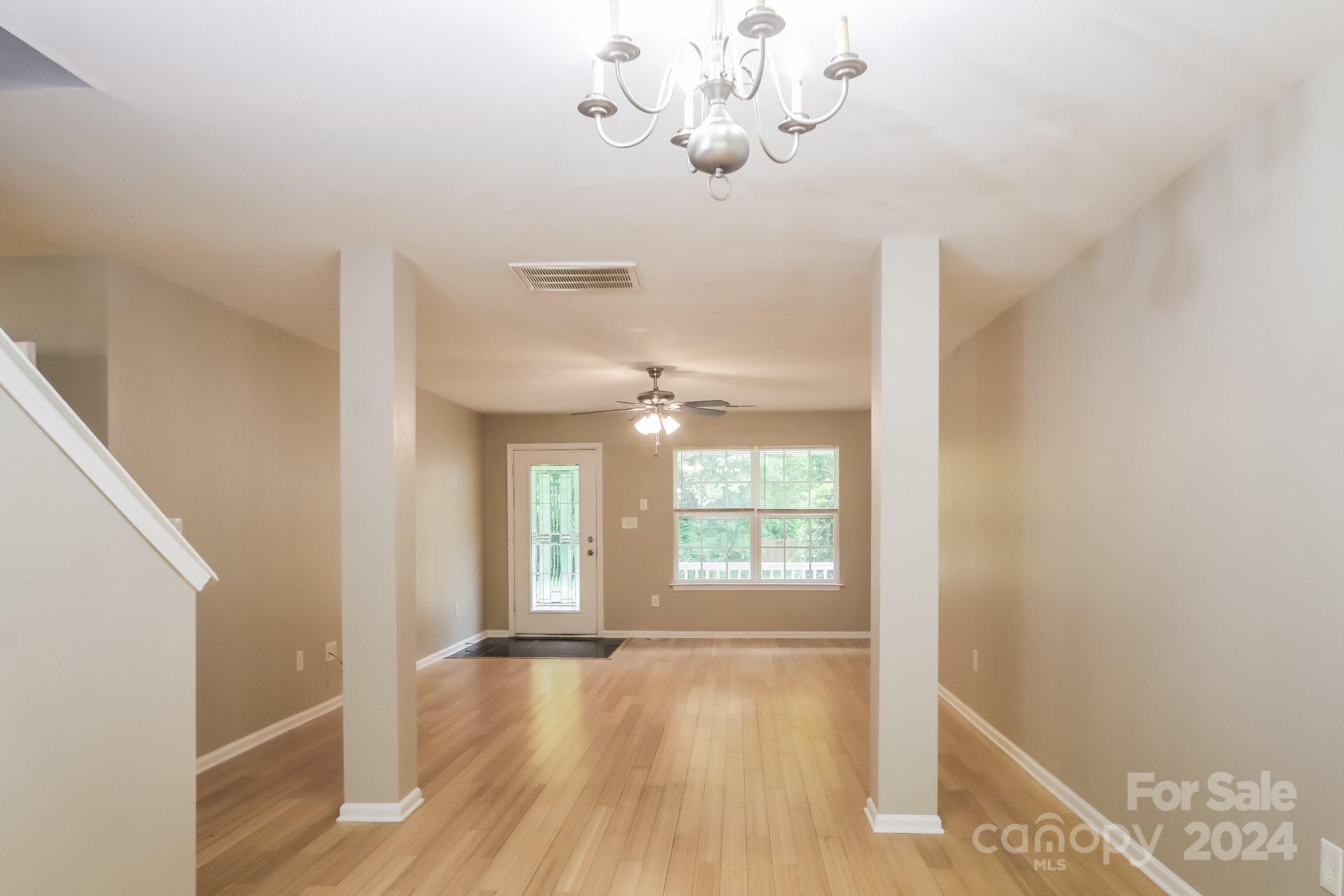 2315 Gooseberry Road Charlotte, NC 28208 - Photo 7 of 22 a view of an empty room with wooden floor and a window