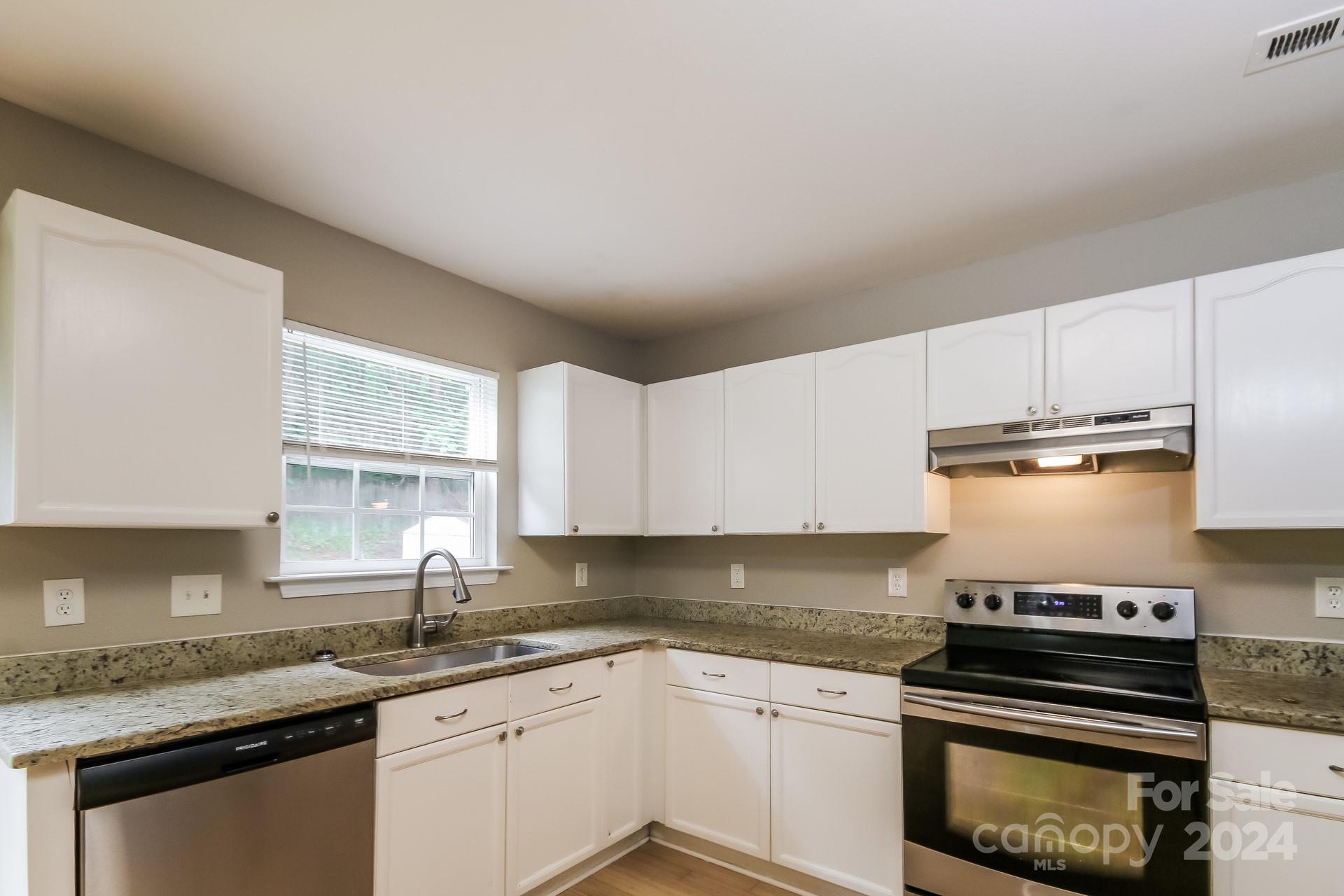 2315 Gooseberry Road Charlotte, NC 28208 - Photo 8 of 22 a kitchen with granite countertop a stove sink and cabinets