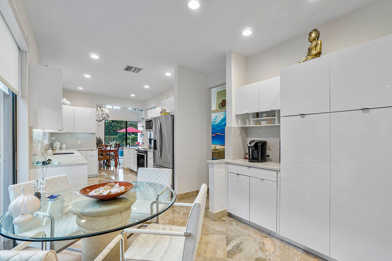 2410 Northwest 53rd Street Boca Raton, FL 33496 - Photo 13 of 25 a kitchen with stainless steel appliances granite countertop a sink and cabinets