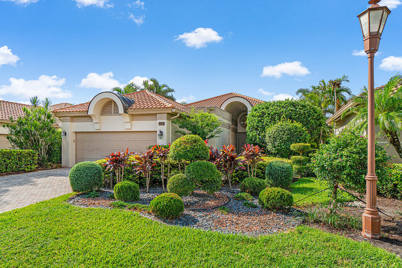 2410 Northwest 53rd Street Boca Raton, FL 33496 - Photo 2 of 25 a front view of a house with a yard