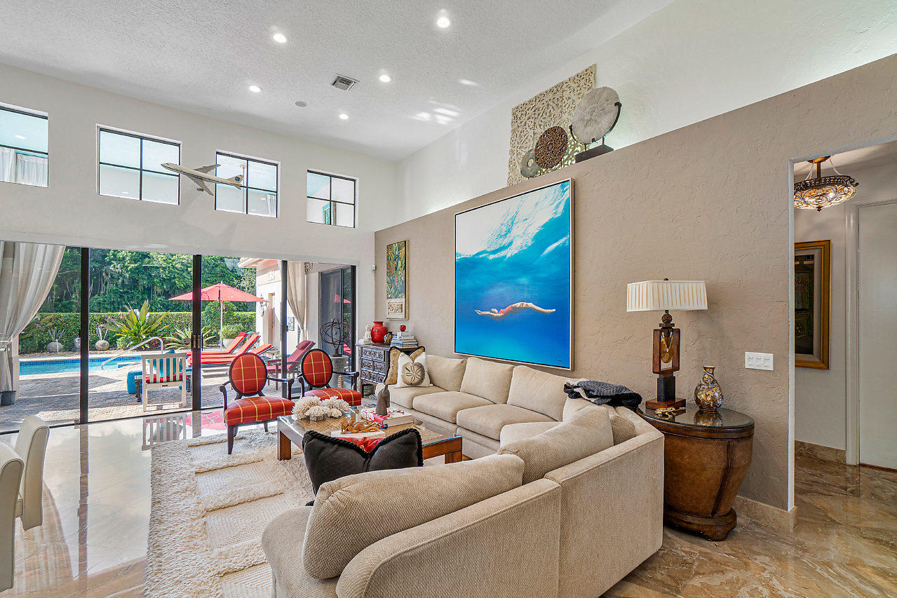 2410 Northwest 53rd Street Boca Raton, FL 33496 - Photo 4 of 25 a living room with furniture and a large window