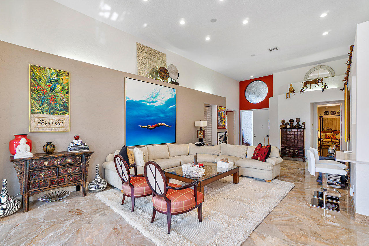 2410 Northwest 53rd Street Boca Raton, FL 33496 - Photo 5 of 25 a living room with furniture and a flat screen tv