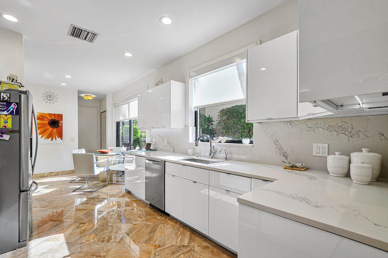 2410 Northwest 53rd Street Boca Raton, FL 33496 - Photo 9 of 25 a kitchen with a sink and wooden floor