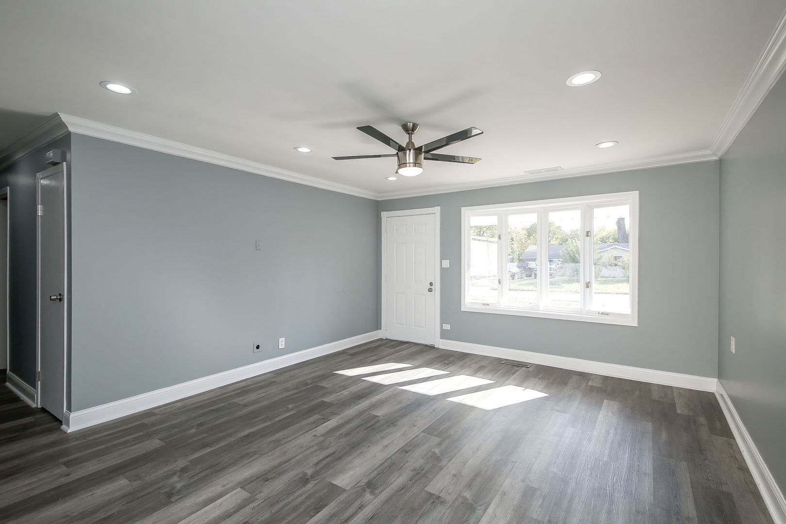 526 White Oak Road Bolingbrook, IL 60440 - Photo 2 of 18 an empty room with wooden floor and windows