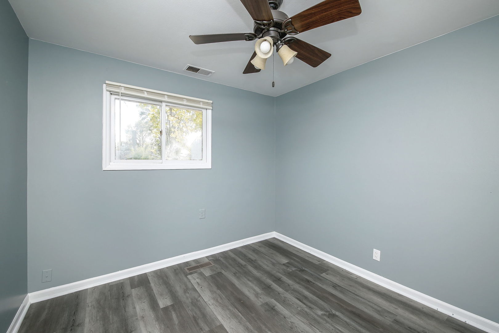 526 White Oak Road Bolingbrook, IL 60440 - Photo 11 of 18 an empty room with wooden floor fan and windows
