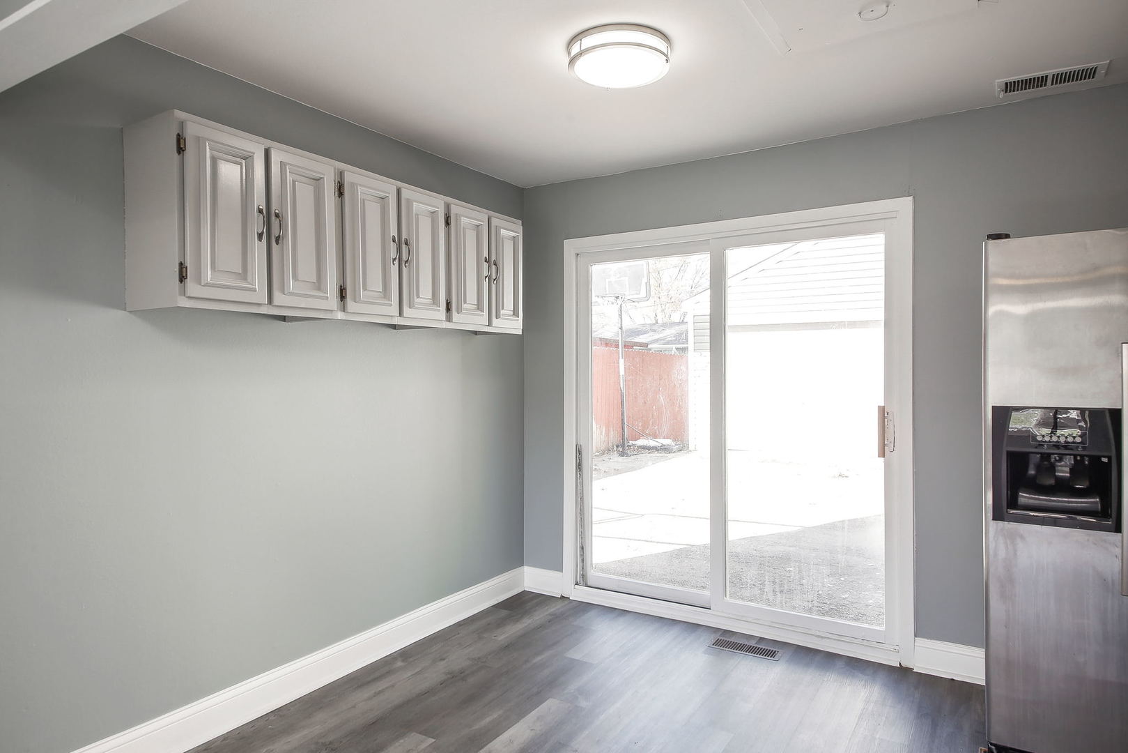 526 White Oak Road Bolingbrook, IL 60440 - Photo 4 of 18 an empty room with wooden floor and windows