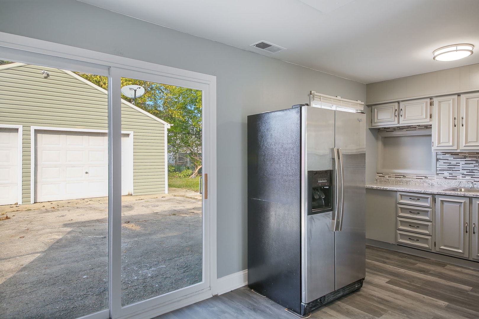 526 White Oak Road Bolingbrook, IL 60440 - Photo 5 of 18 a kitchen with granite countertop a refrigerator and a sink