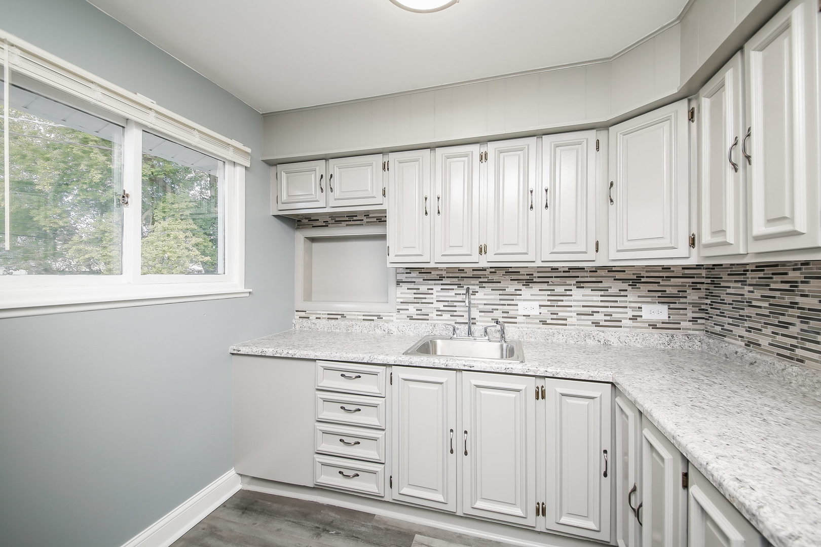 526 White Oak Road Bolingbrook, IL 60440 - Photo 6 of 18 a kitchen with granite countertop white cabinets and white appliances
