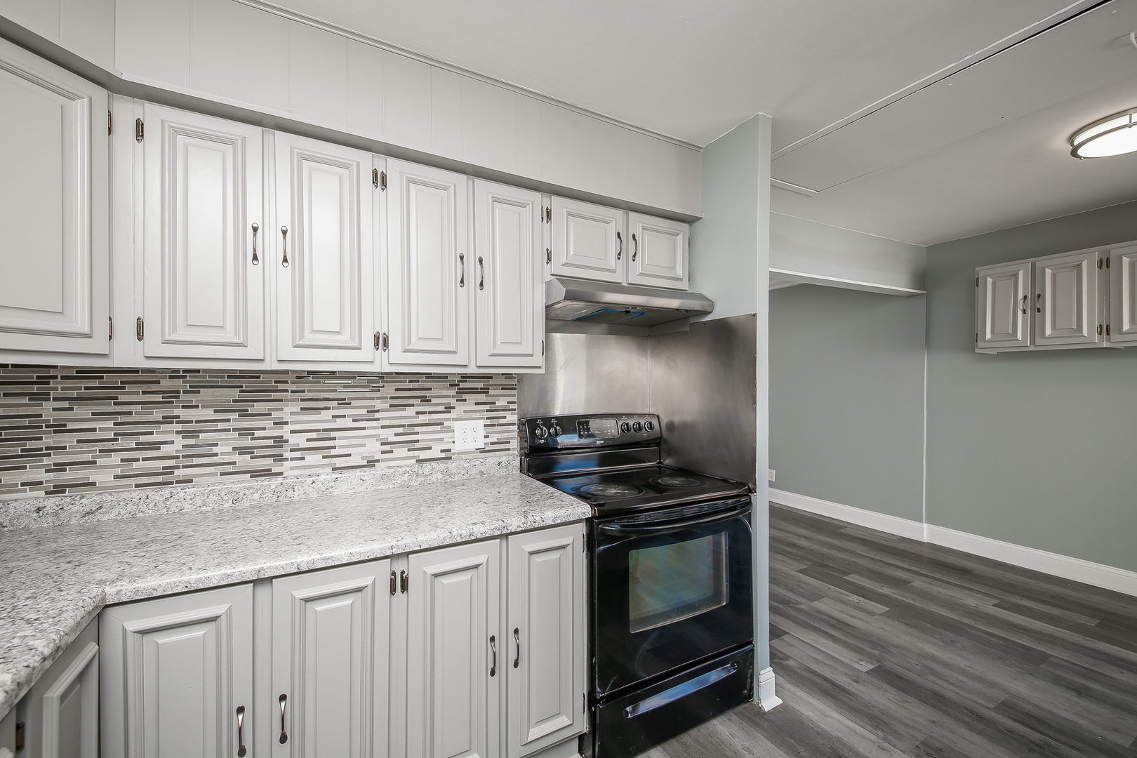 526 White Oak Road Bolingbrook, IL 60440 - Photo 7 of 18 a kitchen with granite countertop a stove and a sink