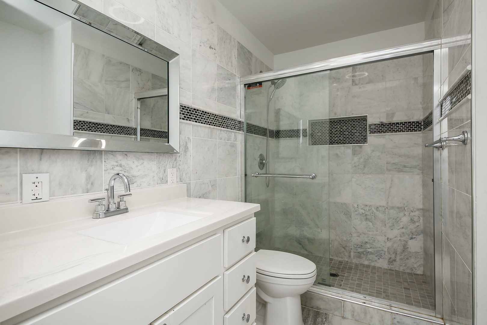526 White Oak Road Bolingbrook, IL 60440 - Photo 9 of 18 a bathroom with a sink toilet a mirror and shower