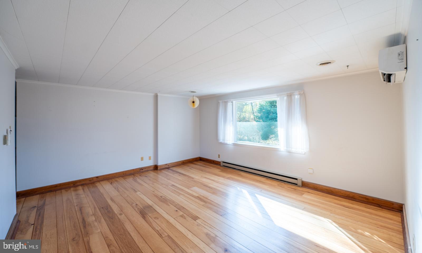 929 North Manor Road Honey Brook, PA 19344 - Photo 12 of 56 a view of an empty room with wooden floor and a window