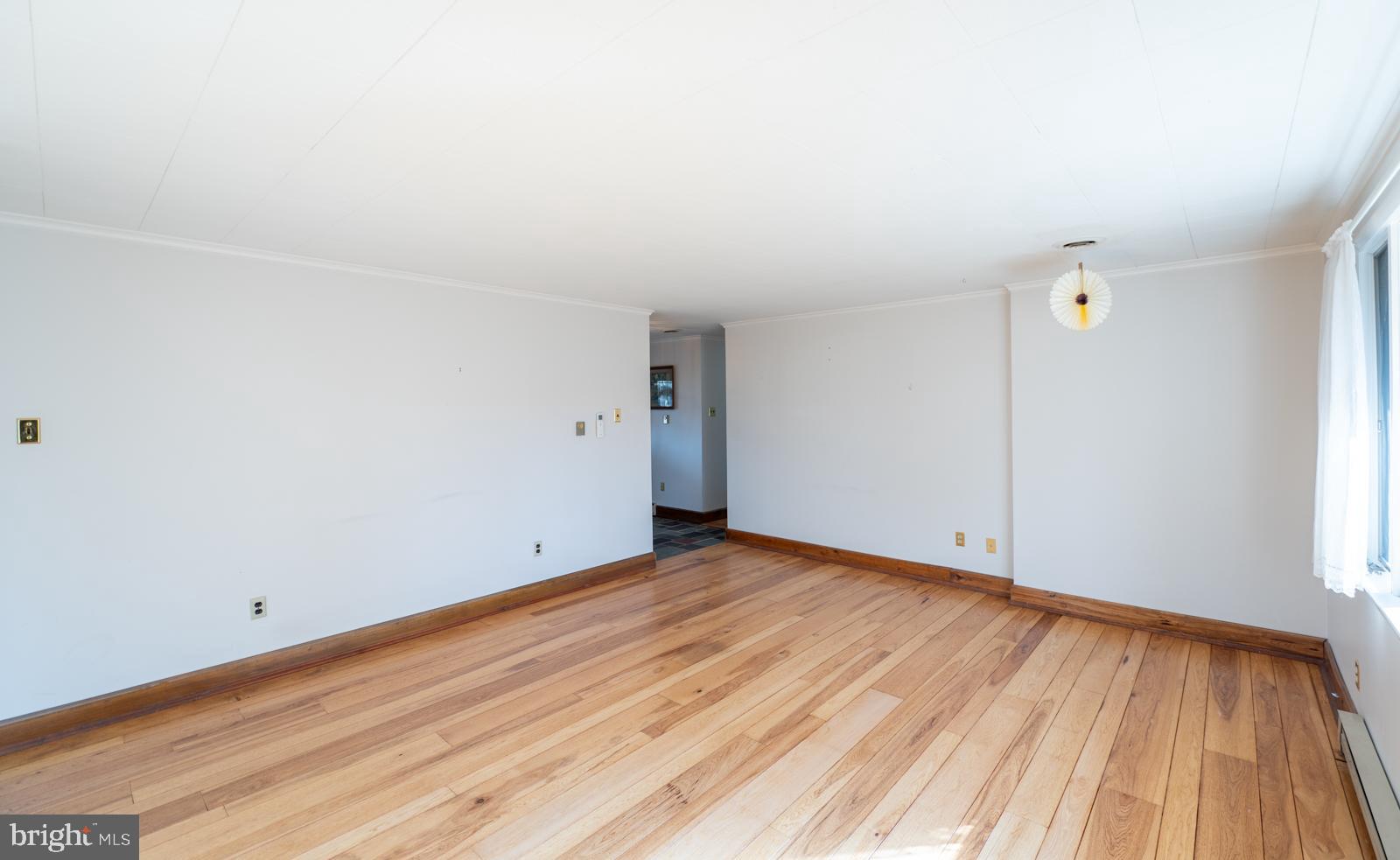 929 North Manor Road Honey Brook, PA 19344 - Photo 15 of 56 a view of an empty room with wooden floor and a window