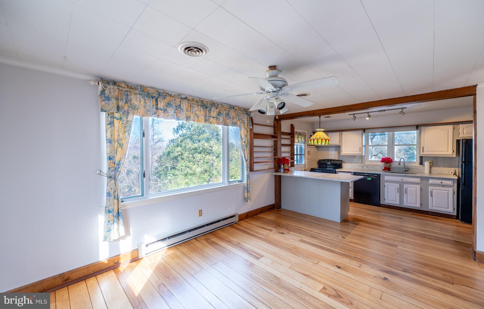 929 North Manor Road Honey Brook, PA 19344 - Photo 9 of 56 a large kitchen with stainless steel appliances a large counter top a sink window and wooden floor
