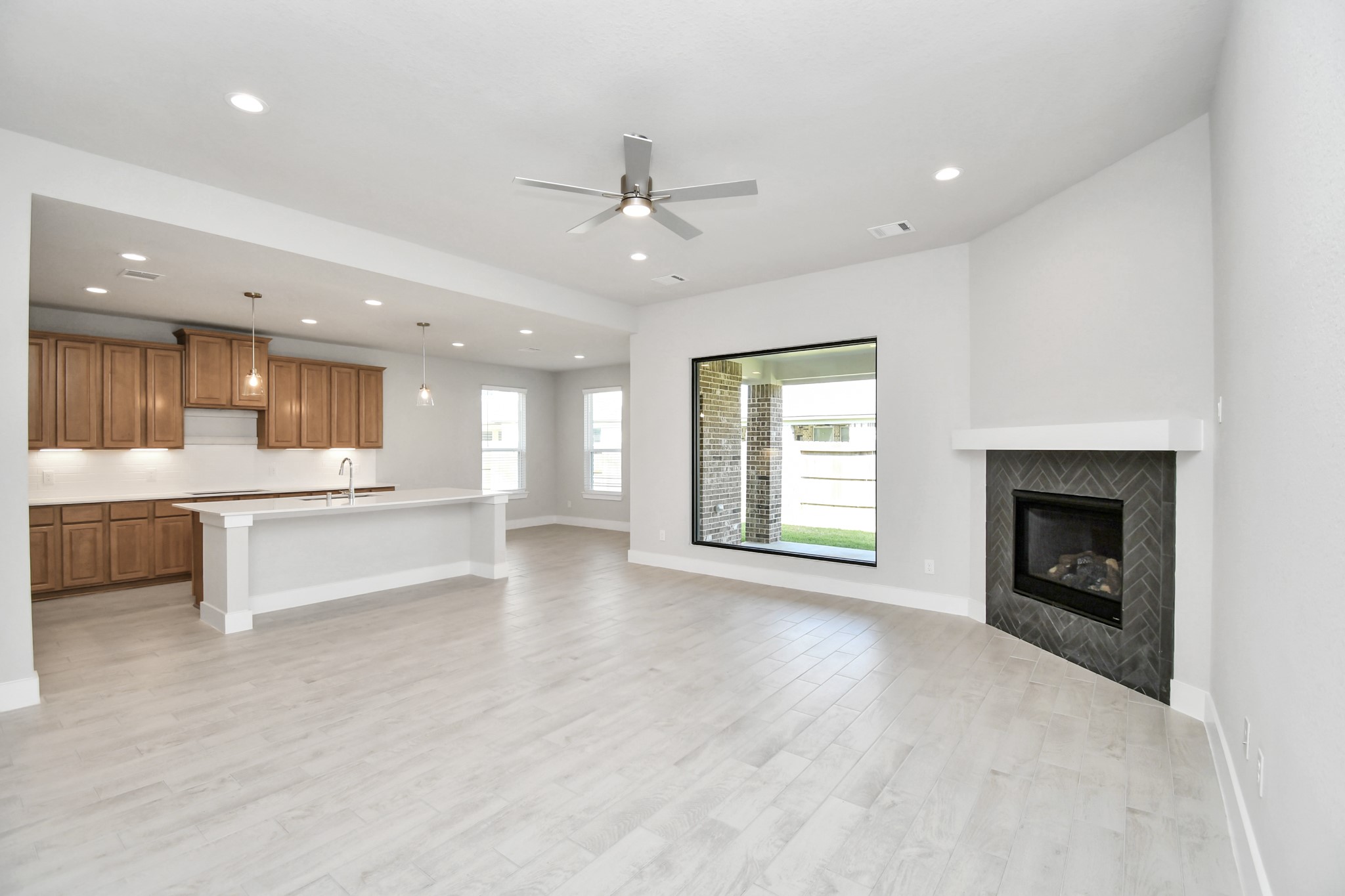 3106 Native Spg Drive Spring, TX 77373 - Photo 17 of 38 Welcome family and guests to your charming living room! With its high ceilings, recessed lighting, ceiling fan, custom paint, beautiful flooring, and a large window that lets in abundant natural light, this room is perfect for gatherings. Sample photo of completed home with similar floor plan. Actual colors and selections may vary.