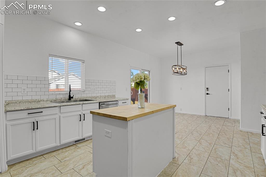12573 Pine Valley Circle Peyton, CO 80831 - Photo 13 of 36 a kitchen that has a sink a window and a counter top space