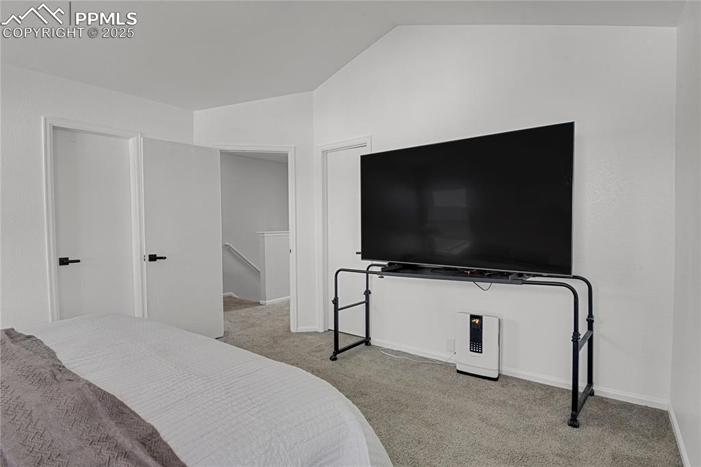 12573 Pine Valley Circle Peyton, CO 80831 - Photo 16 of 36 a bedroom with a bed and a flat screen tv