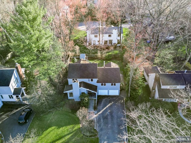aerial view of a house with a garden and trees