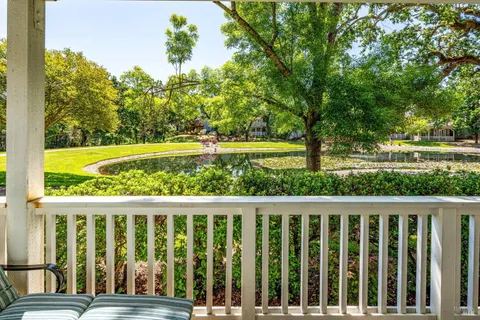 a view of a chairs and table in the balcony