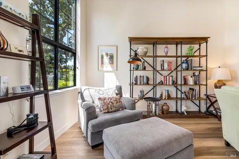 a bedroom with furniture and a large window