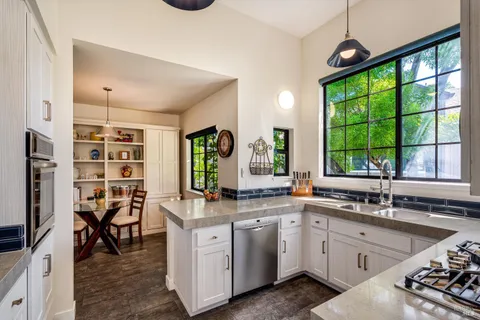 a kitchen with a sink stove and cabinets