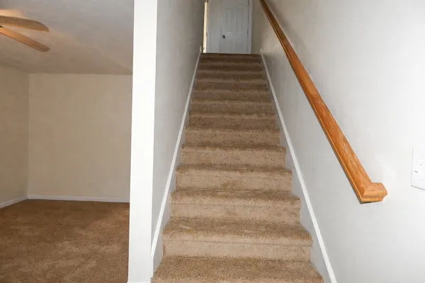 a view of staircase with white walls