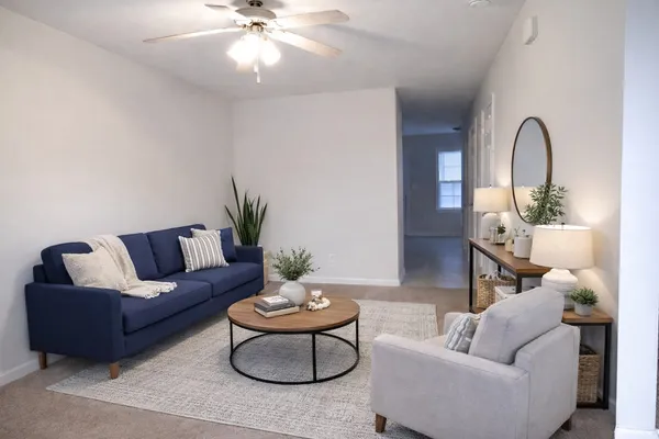 a living room with furniture and a chandelier