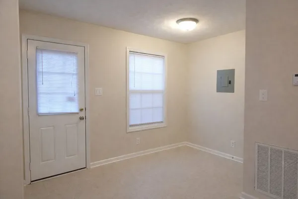 an empty room with windows and closet