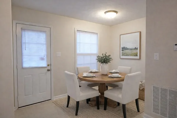 a dining room with furniture and window