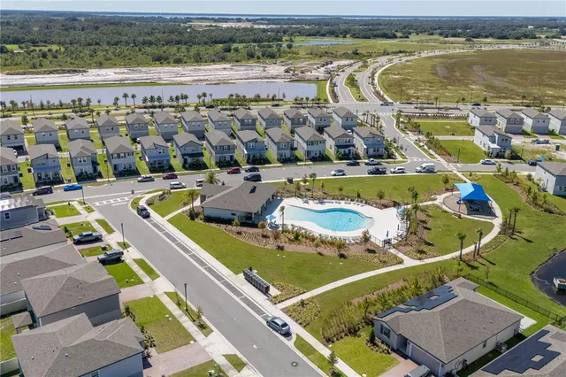 an aerial view of a house with a swimming pool yard and outdoor seating