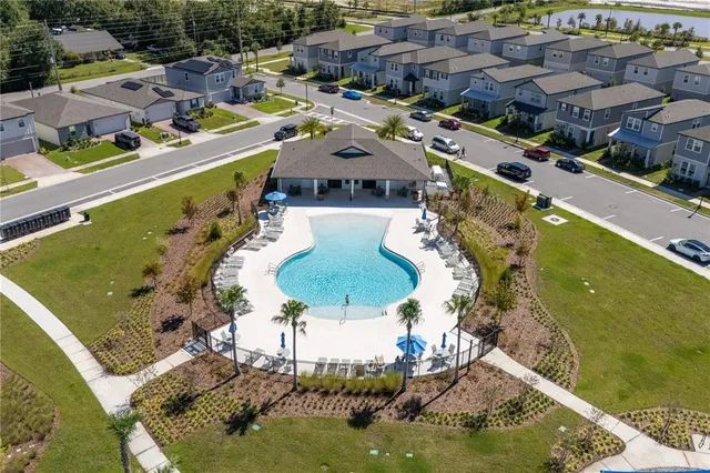 an aerial view of a house with a yard