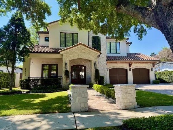 a front view of house with yard and green space
