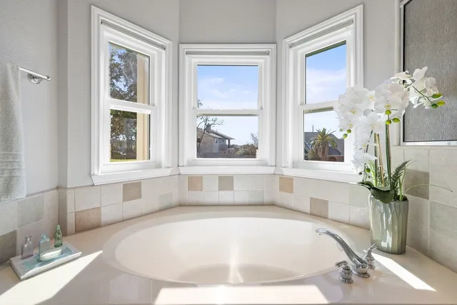 a white bath tub sitting next to a window
