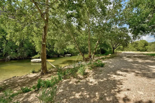 a view of a park with iron fence