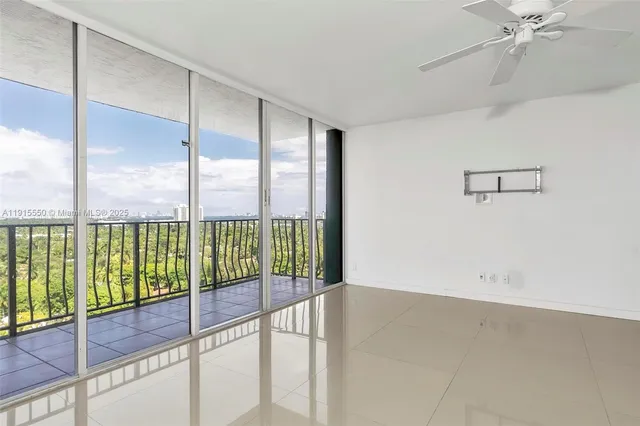 a view of a livingroom with a ceiling fan and window
