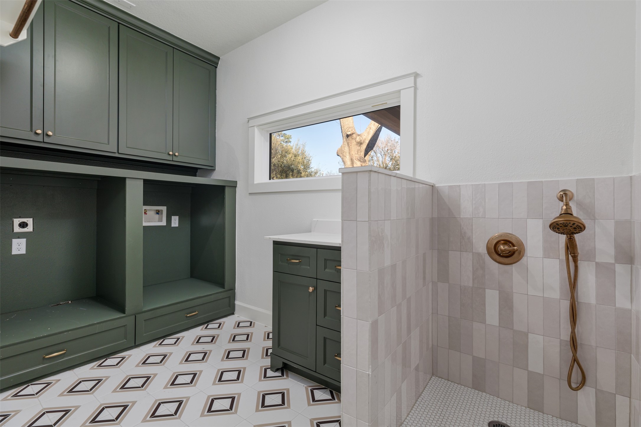 1535 Rutland Street Houston, TX 77008 - Photo 20 of 46 Modern geometric contemporary floor tile make this laundry room pop! The tiled dog wash adds yet another dimension for the functionality of the room. The decorative window above the folding station provide natural light and the cabinets provide additional storage.