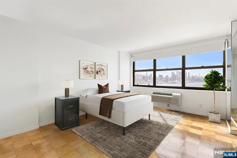 a spacious bedroom with a large bed and a large window