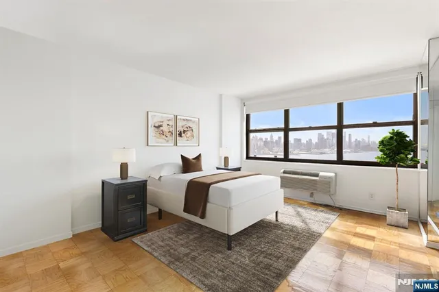 a spacious bedroom with a large bed and a large window