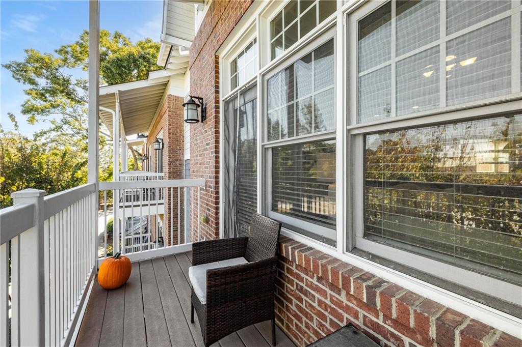 1258 DeKalb Avenue Northeast, Unit 135 Atlanta, GA 30307 - Photo 13 of 45 a view of a balcony with couch and wooden floor