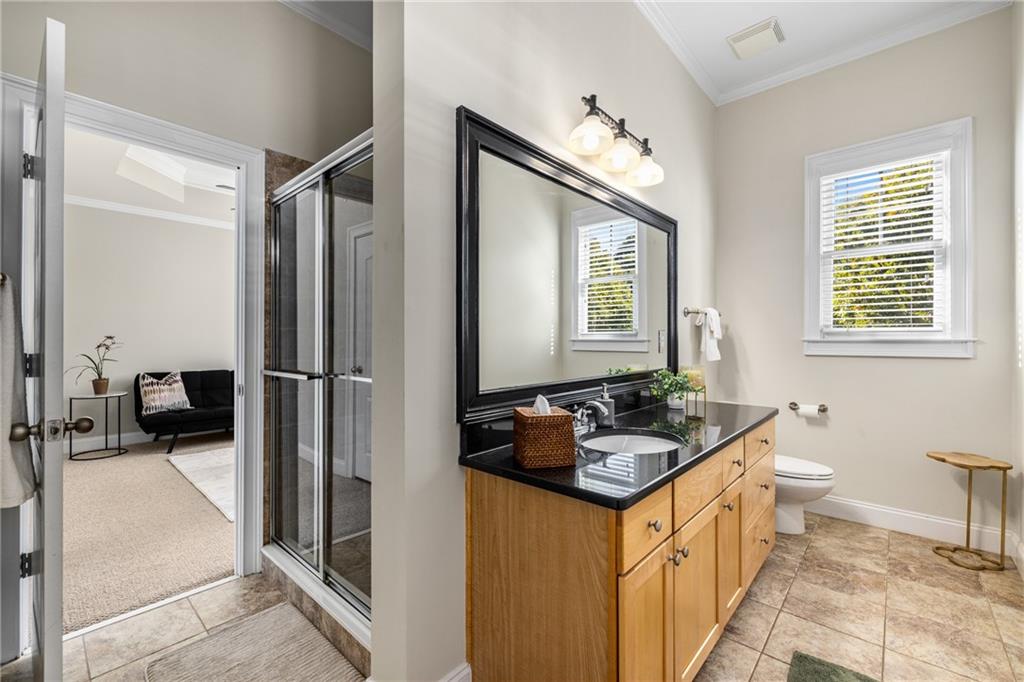 1258 DeKalb Avenue Northeast, Unit 135 Atlanta, GA 30307 - Photo 20 of 45 a bathroom with a granite countertop sink and a mirror