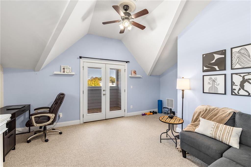 1258 DeKalb Avenue Northeast, Unit 135 Atlanta, GA 30307 - Photo 25 of 45 a living room with furniture and a chair