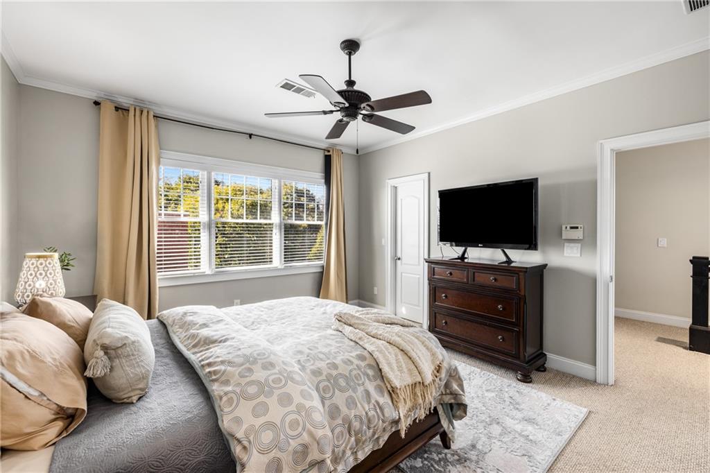 1258 DeKalb Avenue Northeast, Unit 135 Atlanta, GA 30307 - Photo 30 of 45 a bedroom with a bed and a flat screen tv