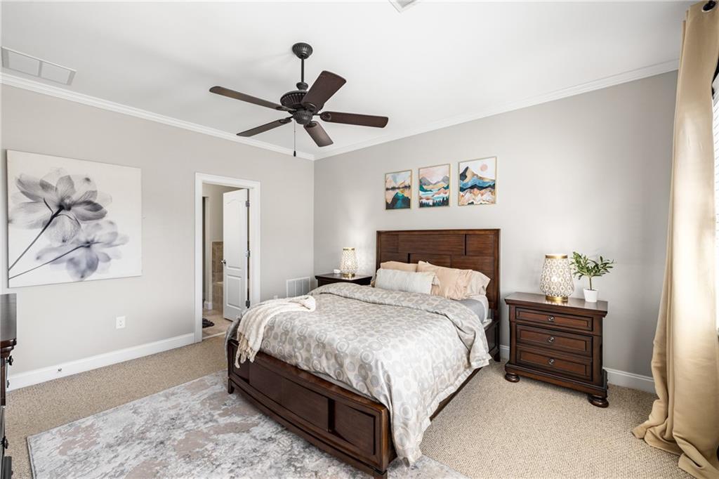 1258 DeKalb Avenue Northeast, Unit 135 Atlanta, GA 30307 - Photo 33 of 45 a bedroom with a bed a window and a painting on the wall