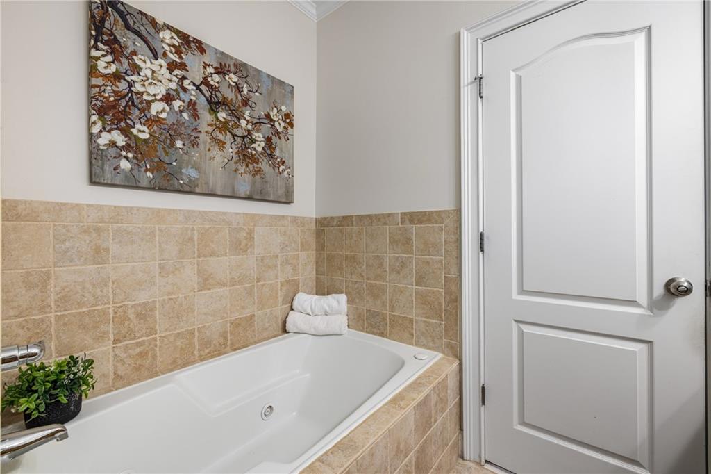 1258 DeKalb Avenue Northeast, Unit 135 Atlanta, GA 30307 - Photo 36 of 45 a bathroom with a bathtub and shower